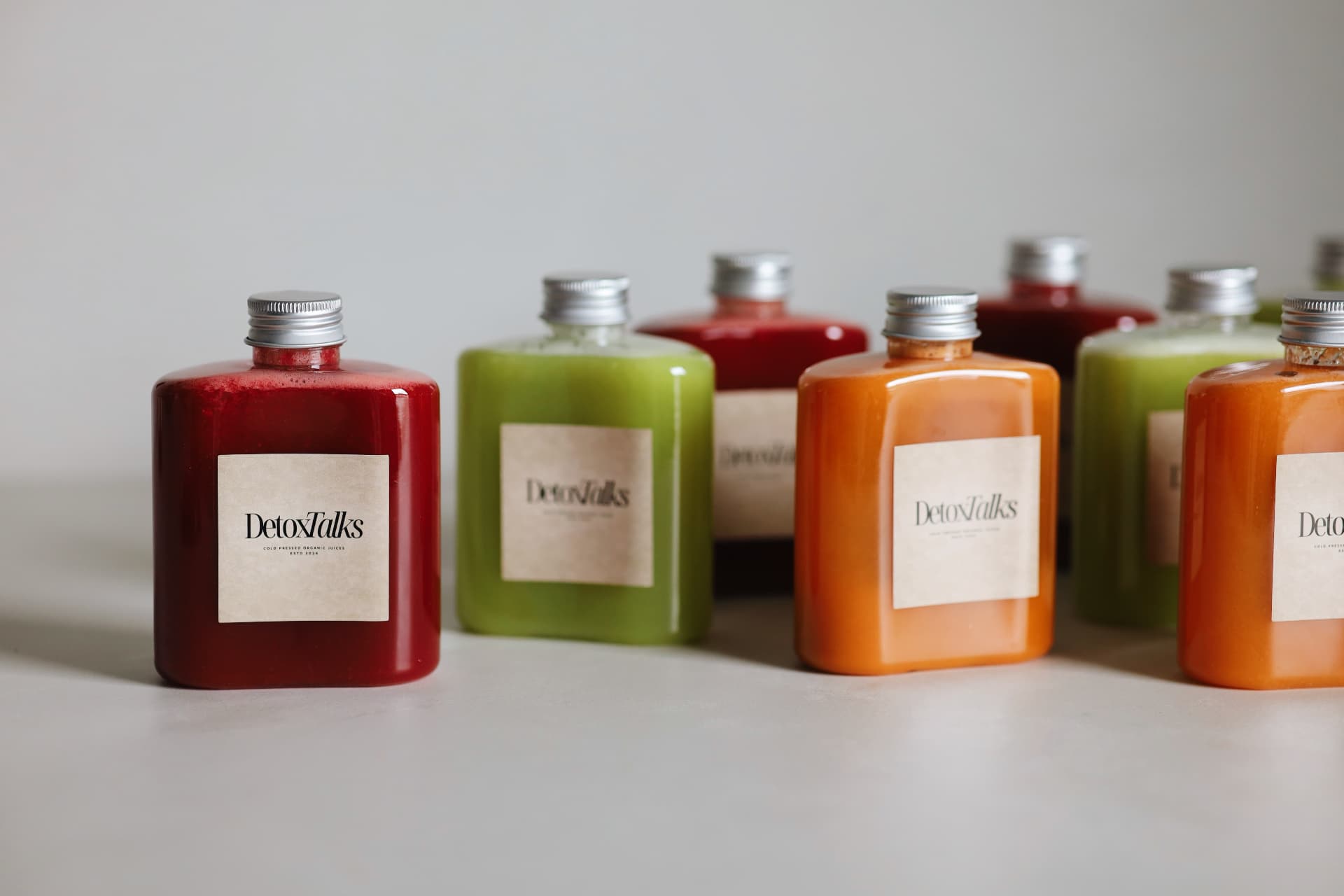 A lineup of Detox Talks Club cold-pressed juice bottles
