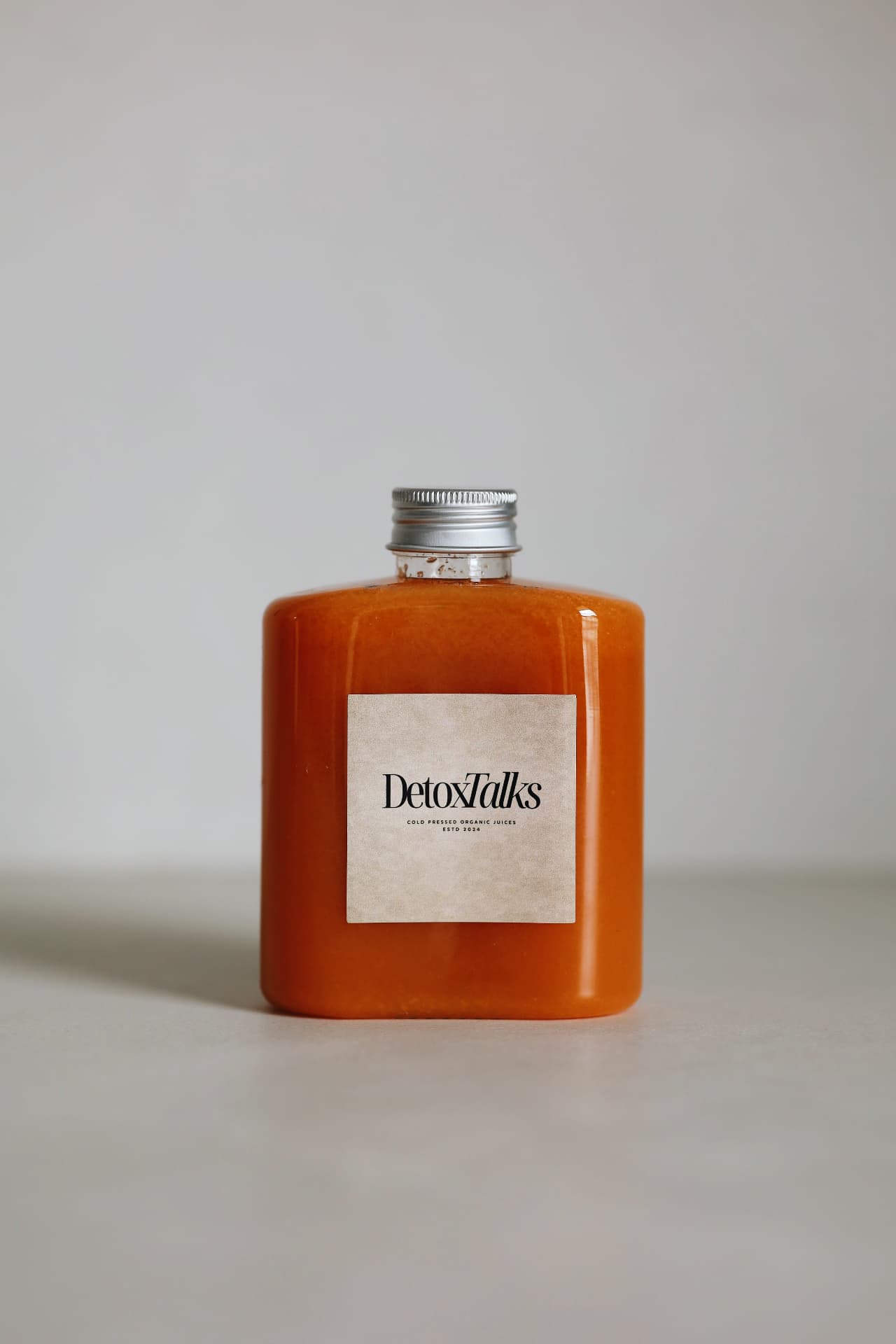 The Golden Glow bottle with the Detox Talks Club label